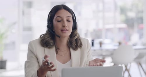 Young female call center agent talking to clients on calls online