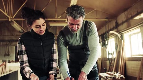 Man and Woman Workers in the Carpentry Workshop