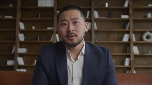 POV Asian Businessman Conversation on Video Call in Office