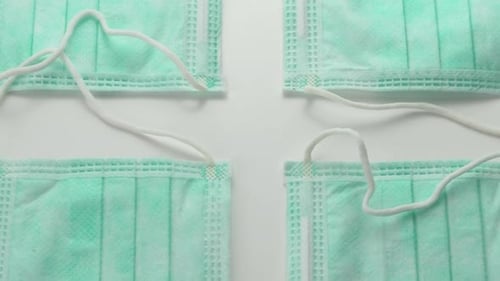 Face surgical Masks side by side displayed in pattern - Overhead slide extreme close up