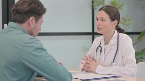 Female Doctor Talking with Patient in Clinic