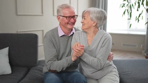 Affectionate Senior Couple Sitting Together on Couch