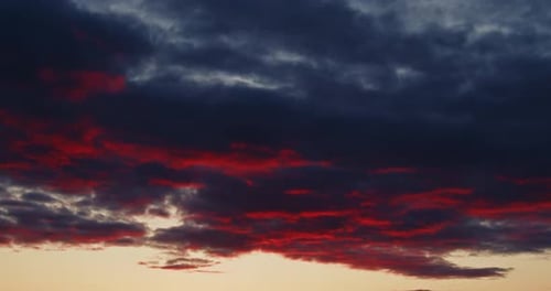 Time Lapse Clouds Illuminated By the Orange Light Sun Setting Over the Horizon