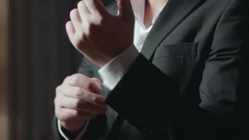 Close Up Of A Man In Jacket Putting On Cuff links. Dressing For Celebration Event
