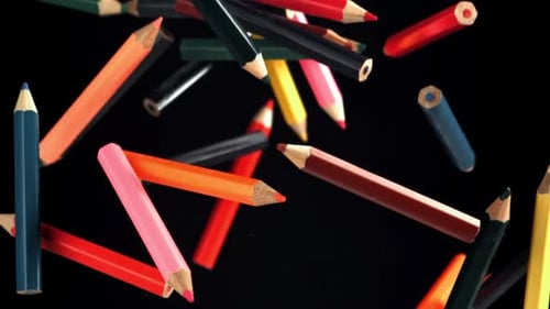 Multicolored Pencils Fly and Fall on a Black Background Filmed on a Highspeed Camera at 1000 Fps
