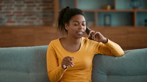 Cheerful Woman Chatting on Mobile Phone Indoors