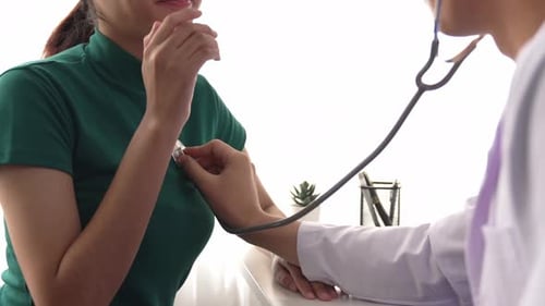 Doctor with stethoscope to check patients's pulse or body in hospital. Rigid.