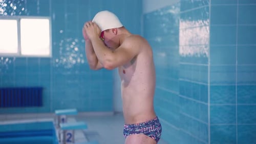 Swimmer Preparing to Dive in Indoor Pool