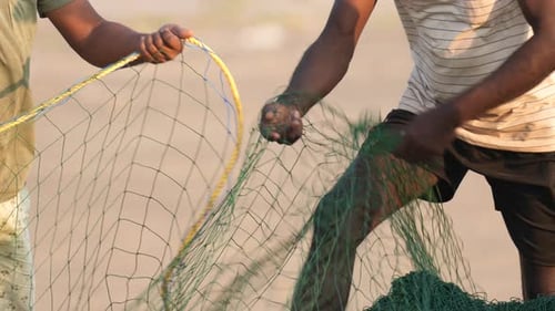 Fisherman prepare fishnet. Fisher sort fish net close up. Men clean fishing mesh
