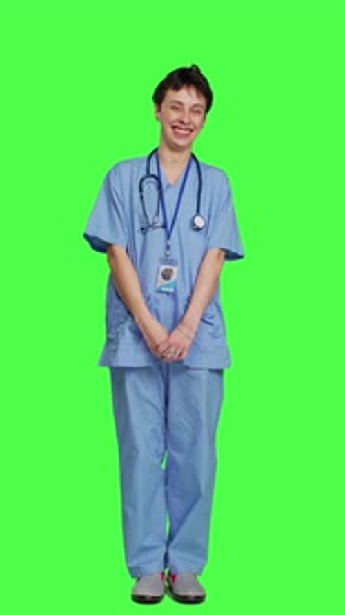 Front View Cheerful Smiling Medical Assistant Standing Against Greenscreen Backdrop