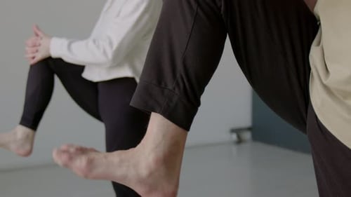 Bare Feet of Dancers Doing Ankle Rotation Exercise during Warmup in Studio