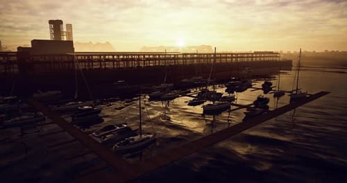 Sunset Over Tranquil Marina with Moored Sailboats and Calm Waters