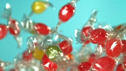 Colorful Wrapped Candies Floating Against a Blue Backdrop