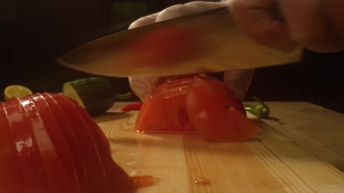 Chef Slicing Fresh Tomatoes