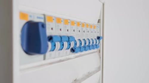 Man flipping a single circuit breaker switch on and off. Electrical cabinet. Close up