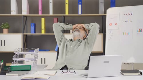 Stressed Man Working on Laptop at Office Desk
