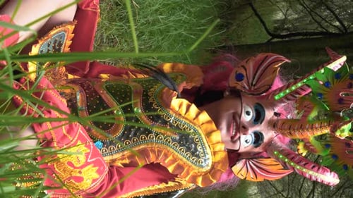 Vertical Shot of Diablada Pillareña Performer in Forest, Arcing Camera Shot