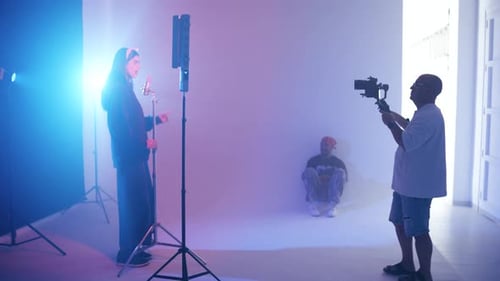 Cameraman Recording a Female Singer in a Music Video Production