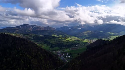 A Mountain Village in a Valley Under Mountains and Forests The First Green Trees in Spring Fluffy