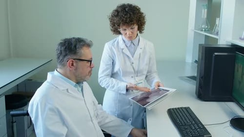 Scientists Reviewing Medical Data in Modern Laboratory