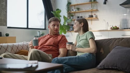 Couple Relaxing and Talking on Couch at Home