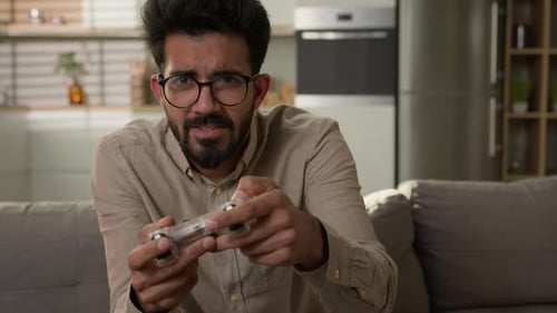 Man Playing Video Games on Couch at Home