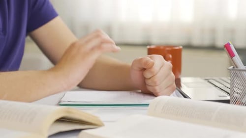 Studious Young Adult at Desk with Books