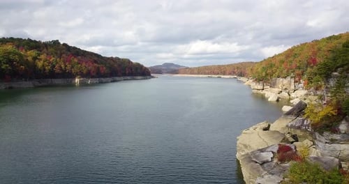 slow-motion drone shot up a river in West Virginia with stunning autumnal trees