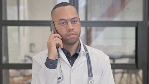 Focused Doctor Talking on Phone