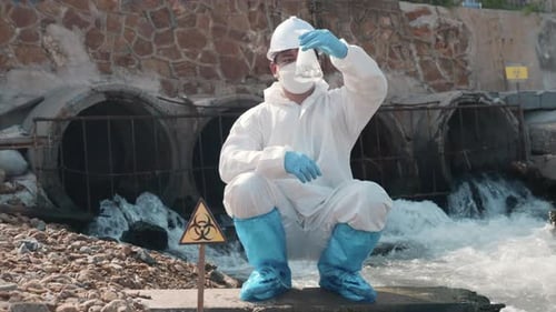 Ecologist Sampling Water Toxic Chemicals From River with Test Tube Glass and Have White Smoke