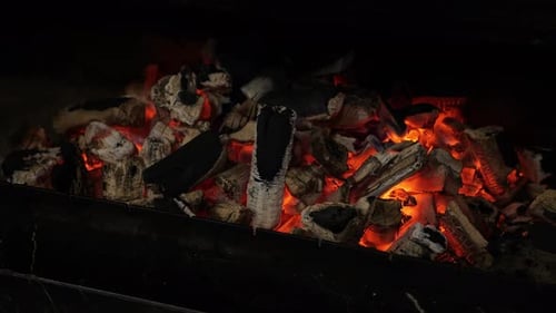 Burning Hot Charcoal Embers Glow in the Darkness