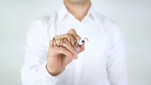 Man Writes 'News' on Clear Surface with Marker