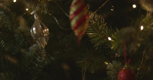 Happy New Year Christmas Tree Decorates on Branch Snow on Background Bokeh of Side Flickering Light