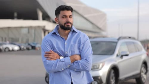 Confident Handsome Driver Posing with Crossing Hands Against Car