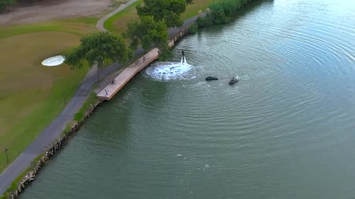 Aerial View Adventurous Female Flyboarder Over River at Dusk