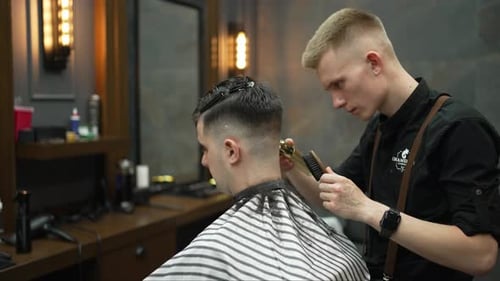 Barber Cutting Hair in Modern Barber Shop