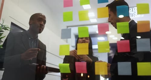 Multiracial Colleagues Working Inside Business Office with Glass Walls - Entrepreneurs People