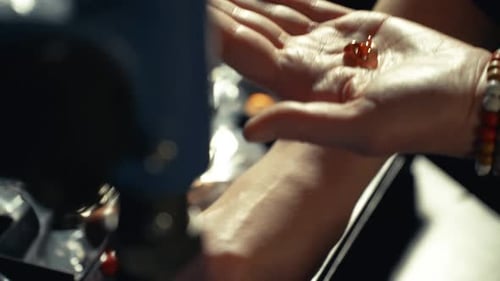 Close-Up of Hands Stringing Beads in Workshop