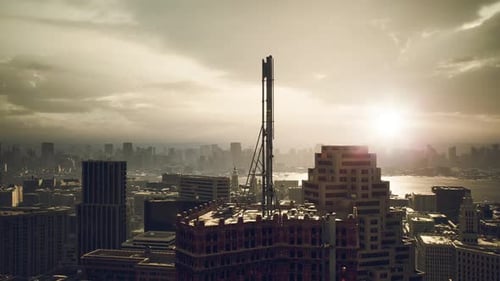 Sunset Over a Sprawling City Skyline with a Communication Tower in View