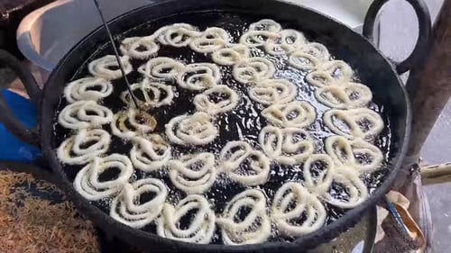 Fresh Jalebi or Jilebi Jangri made at a roadside stall in India during mela.