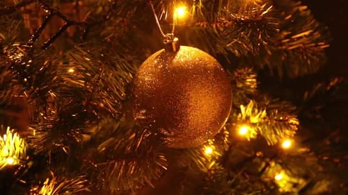 Golden Christmas Ornament Hanging on a Tree