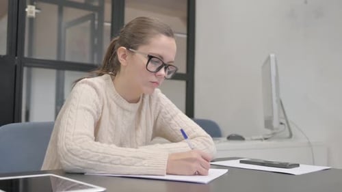 Close up of Woman Writing on Paper