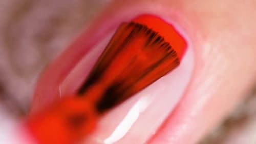 Applying Red Nail Polish Close Up Shot