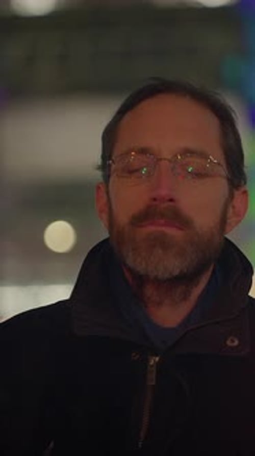 Man in Glasses Standing at Night in City