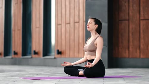 Sport Woman Practicing Yoga Meditation in Lotus Posture with Hands Namaste Relaxing Training Outdoor