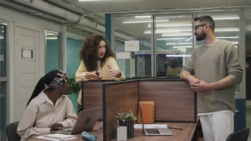 Three Diverse Colleagues Discussing Work Problem in Office