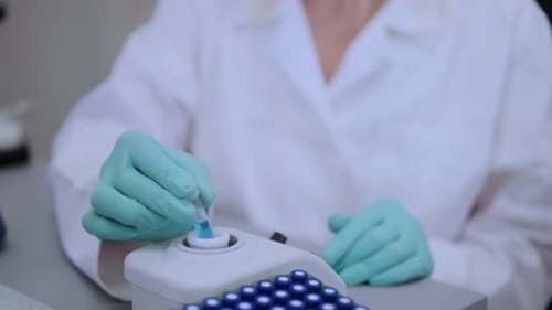 Close Up Laboratory Worker Uses Vortex for Mixing Samples in HPLC Vials