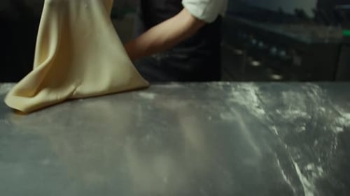 Chef Rolls Out Thin Pastry To Make Tortellini Bolognese In A Restaurant