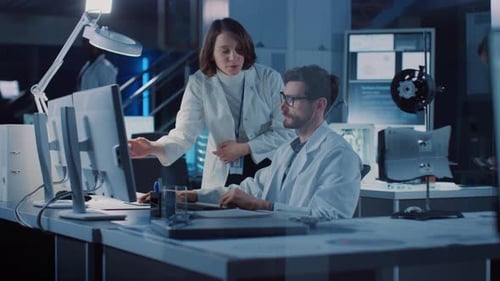 Scientists Collaborate at Computer Workstation in Laboratory