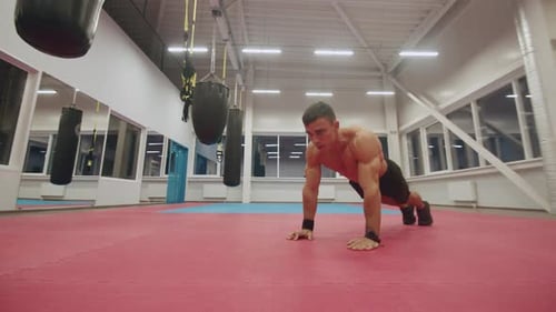 Young Muscular Man with Naked Torso Doing a Training in the Gym with His Own Weight and Doing